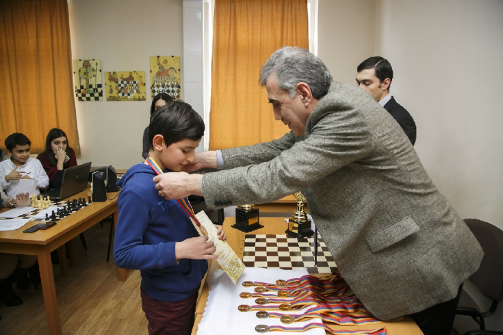 Receiving a chess medal at a junior tournament